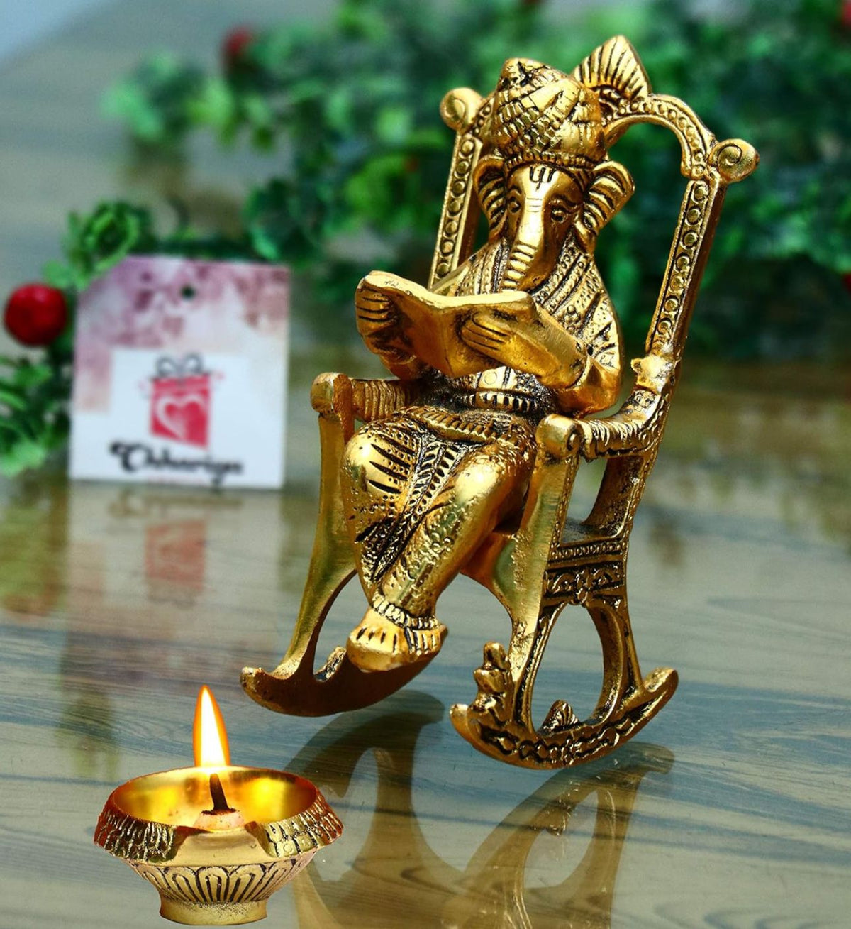 Metal Lord Ganesh Reading Ramayana Statue Ganpati Sitting on Chair with Kuber Diya in Berlin