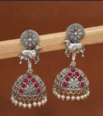 Oxidized Silver Kamdhenu Cow Motif Jhumka Earrings with Red Stones & Pearl Drops in Germany
