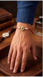Elegant Handcrafted Kundan and Pearl Rakhi on Wrist in Germany